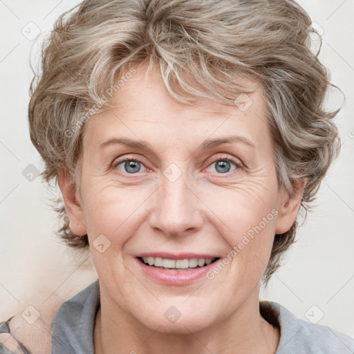 Joyful white adult female with medium  brown hair and blue eyes