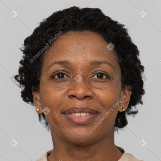 Joyful black adult female with short  brown hair and brown eyes