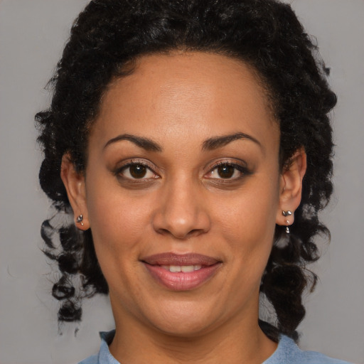 Joyful black adult female with short  brown hair and brown eyes