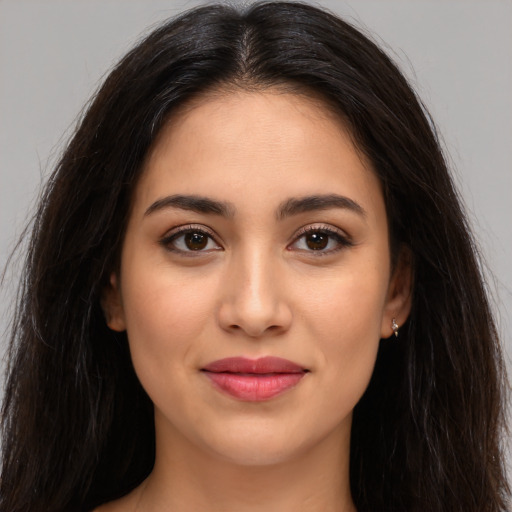 Joyful latino young-adult female with long  brown hair and brown eyes