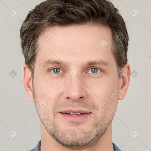 Joyful white adult male with short  brown hair and grey eyes