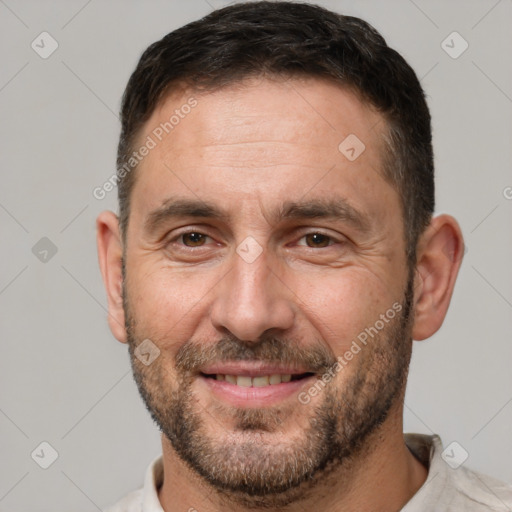 Joyful white adult male with short  brown hair and brown eyes