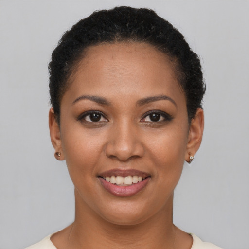 Joyful latino young-adult female with short  brown hair and brown eyes