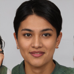 Joyful asian young-adult female with medium  brown hair and brown eyes