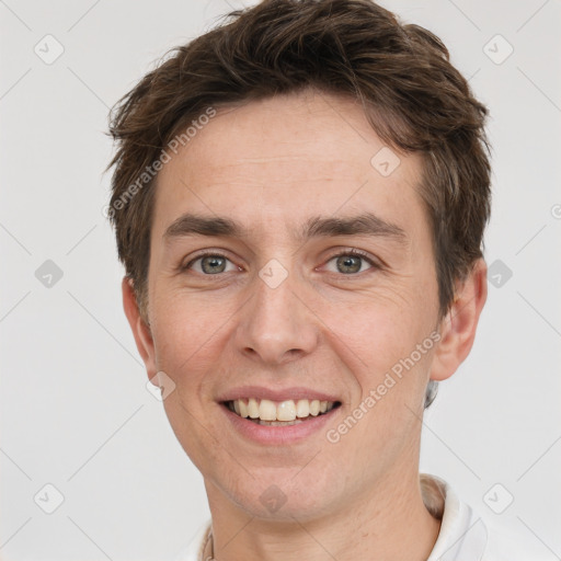 Joyful white adult male with short  brown hair and grey eyes