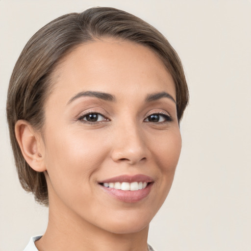 Joyful white young-adult female with medium  brown hair and brown eyes