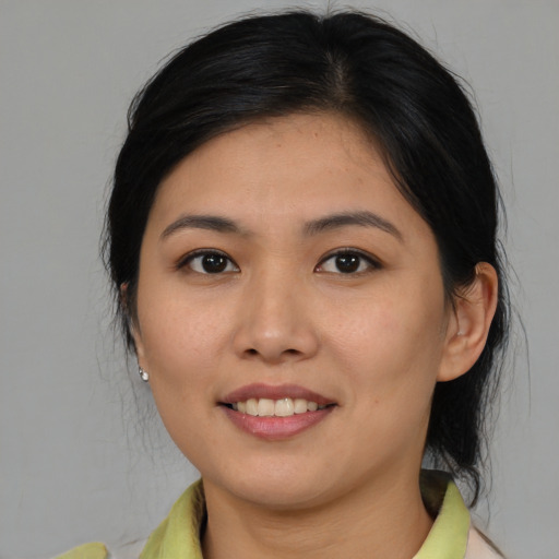 Joyful asian young-adult female with medium  brown hair and brown eyes