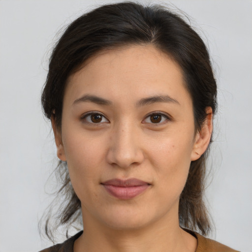 Joyful latino young-adult female with medium  brown hair and brown eyes