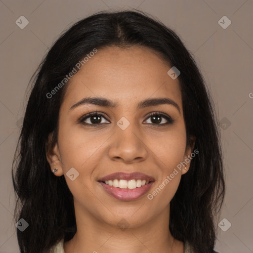 Joyful latino young-adult female with long  brown hair and brown eyes