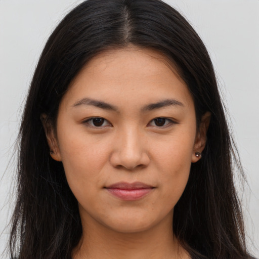 Joyful asian young-adult female with long  brown hair and brown eyes