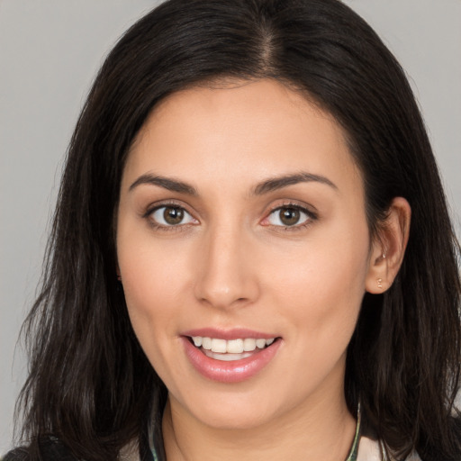 Joyful white young-adult female with long  brown hair and brown eyes