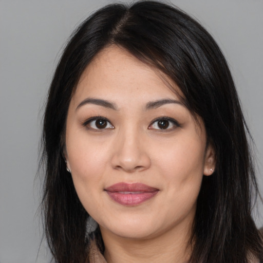 Joyful latino young-adult female with long  brown hair and brown eyes