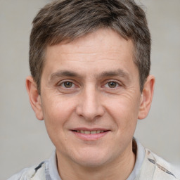 Joyful white adult male with short  brown hair and brown eyes