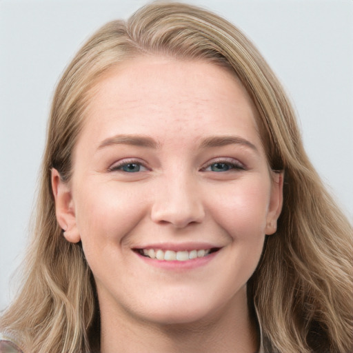 Joyful white young-adult female with long  brown hair and blue eyes