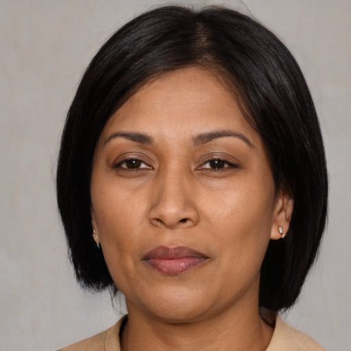 Joyful asian adult female with medium  black hair and brown eyes