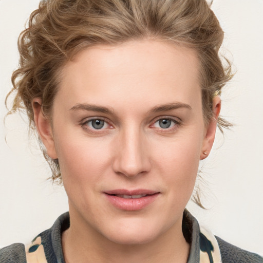 Joyful white young-adult female with medium  brown hair and blue eyes