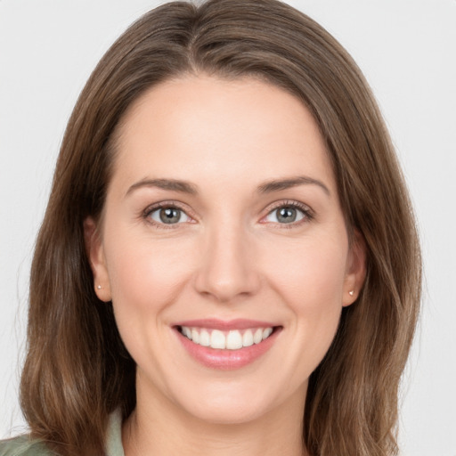 Joyful white young-adult female with medium  brown hair and green eyes