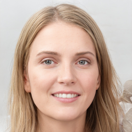 Joyful white young-adult female with long  brown hair and blue eyes