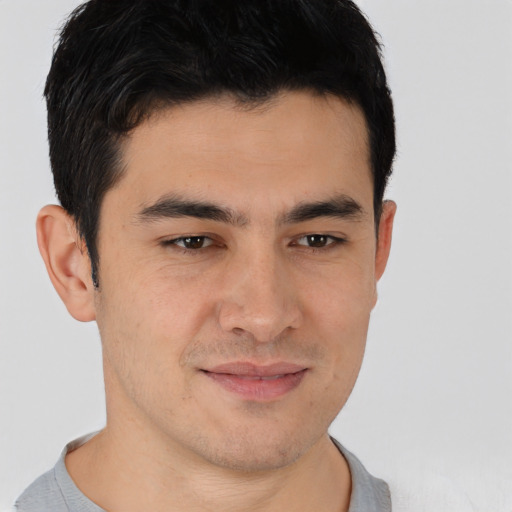 Joyful asian young-adult male with short  brown hair and brown eyes