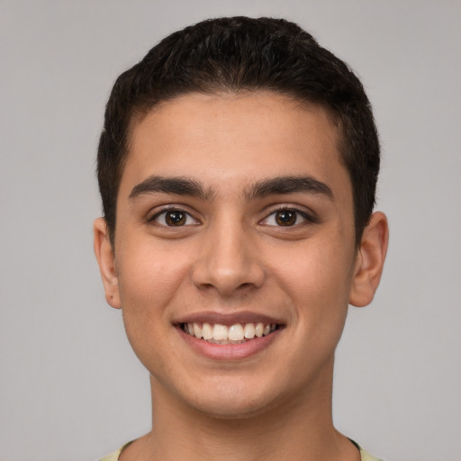 Joyful white young-adult male with short  brown hair and brown eyes