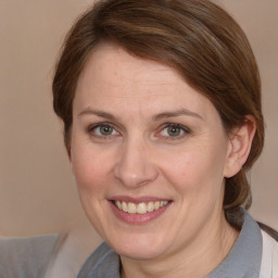 Joyful white adult female with medium  brown hair and brown eyes