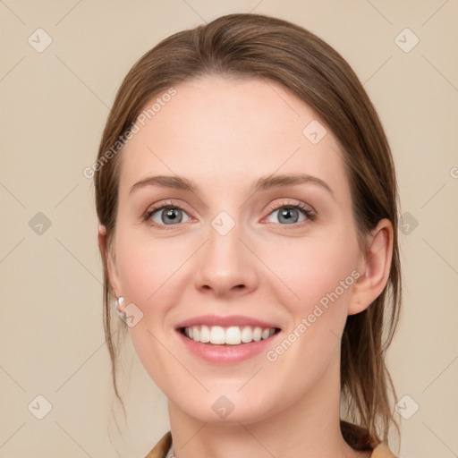 Joyful white young-adult female with long  brown hair and green eyes