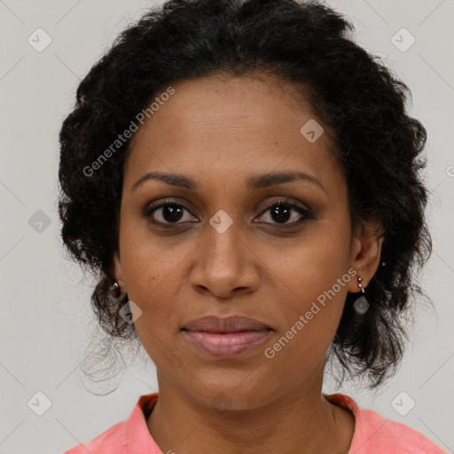 Joyful black adult female with medium  brown hair and brown eyes