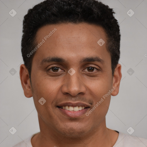Joyful latino young-adult male with short  black hair and brown eyes