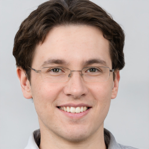 Joyful white adult male with short  brown hair and grey eyes