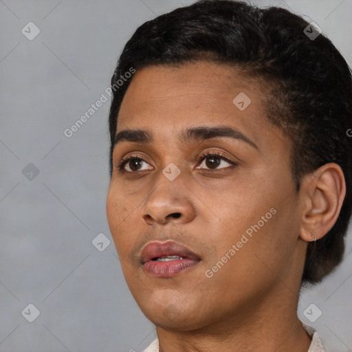 Joyful black young-adult female with short  black hair and brown eyes