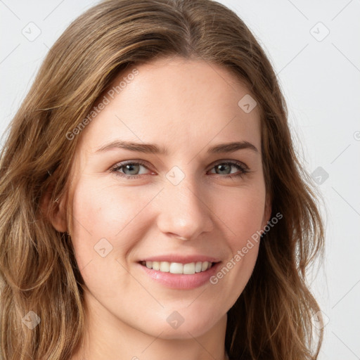 Joyful white young-adult female with long  brown hair and green eyes