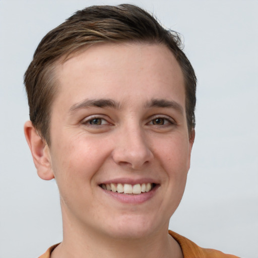 Joyful white young-adult female with short  brown hair and grey eyes