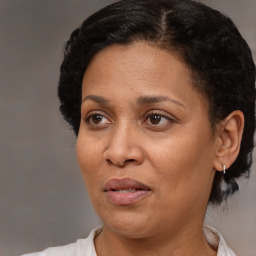 Joyful black adult female with short  brown hair and brown eyes