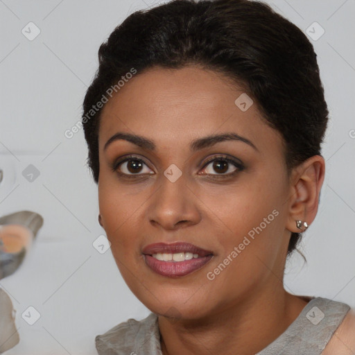 Joyful black young-adult female with short  brown hair and brown eyes