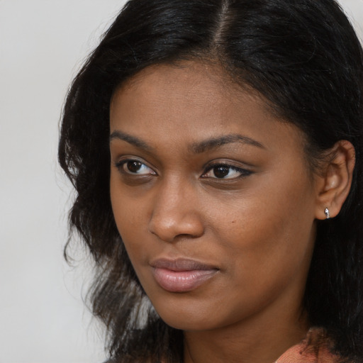 Neutral black young-adult female with medium  brown hair and brown eyes