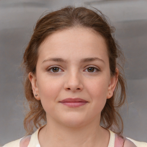 Joyful white child female with medium  brown hair and brown eyes