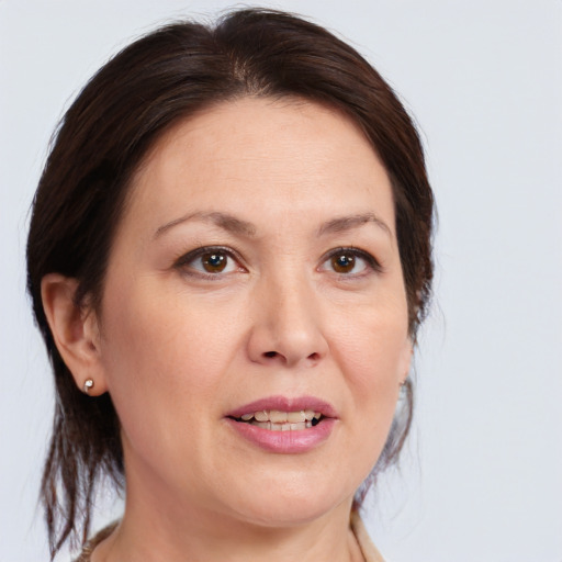 Joyful white adult female with medium  brown hair and brown eyes