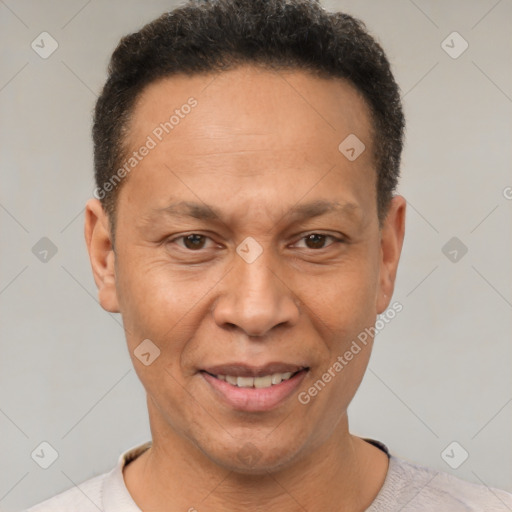 Joyful latino adult male with short  brown hair and brown eyes