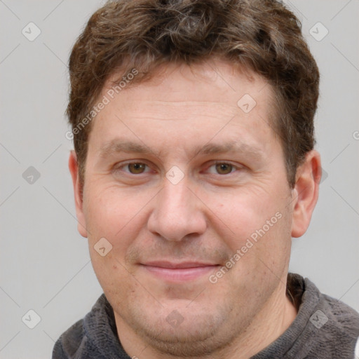 Joyful white adult male with short  brown hair and grey eyes