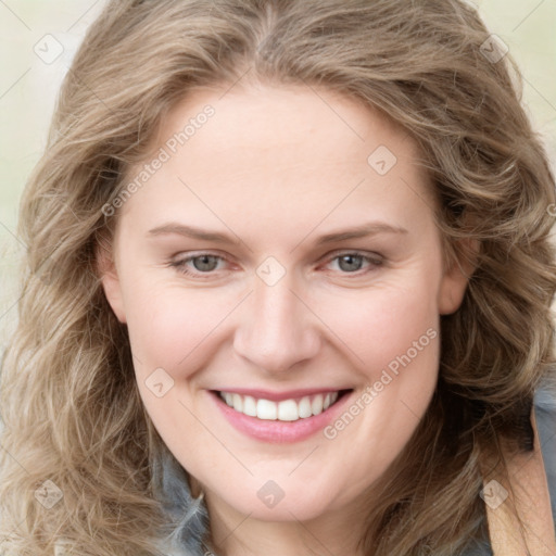 Joyful white young-adult female with long  brown hair and blue eyes