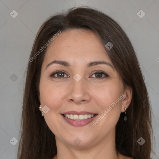 Joyful white adult female with long  brown hair and brown eyes