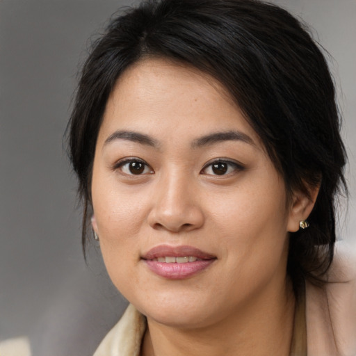 Joyful asian young-adult female with medium  brown hair and brown eyes
