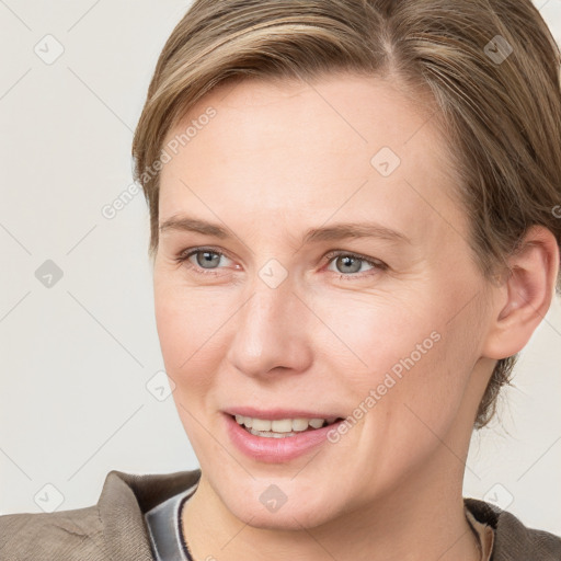 Joyful white young-adult female with medium  brown hair and blue eyes