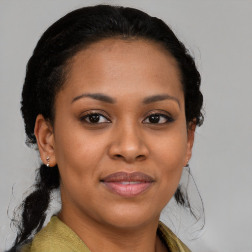 Joyful black young-adult female with medium  black hair and brown eyes
