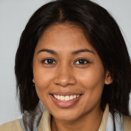 Joyful black young-adult female with medium  brown hair and brown eyes