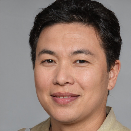 Joyful white adult male with medium  brown hair and brown eyes
