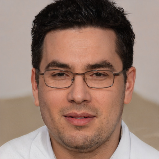 Joyful white adult male with short  brown hair and brown eyes