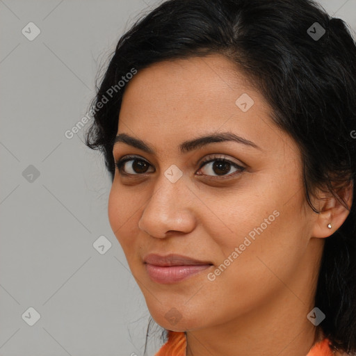 Joyful latino young-adult female with long  brown hair and brown eyes