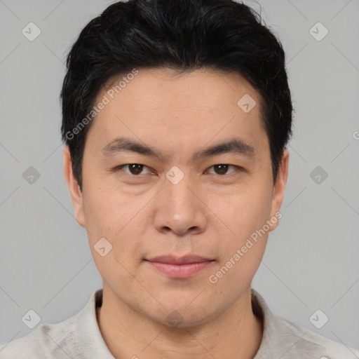 Joyful asian young-adult male with short  brown hair and brown eyes