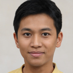 Joyful asian young-adult male with short  black hair and brown eyes